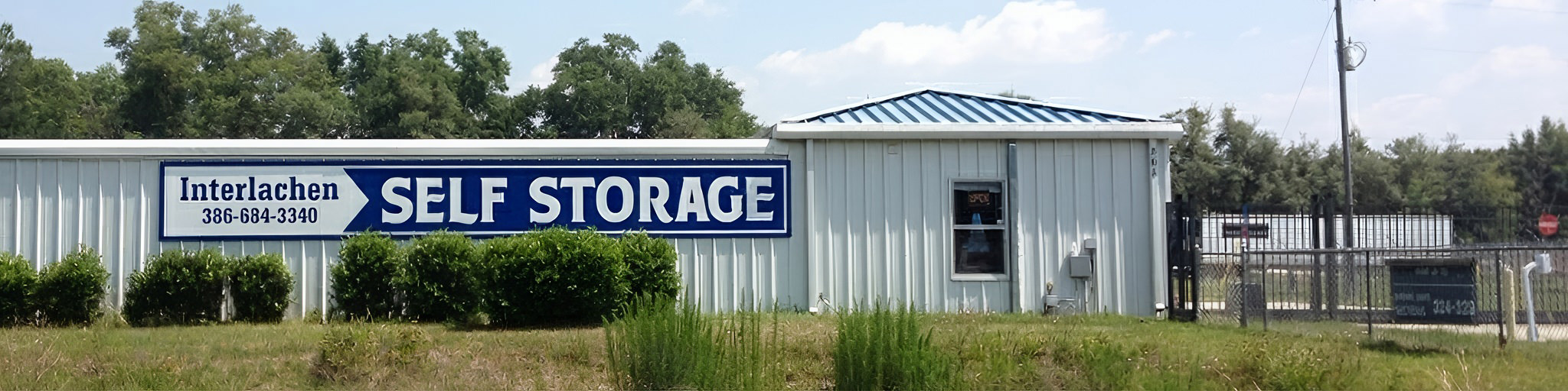 Exterior view of Interlachen Self Storage facility showing storage units and security gate
